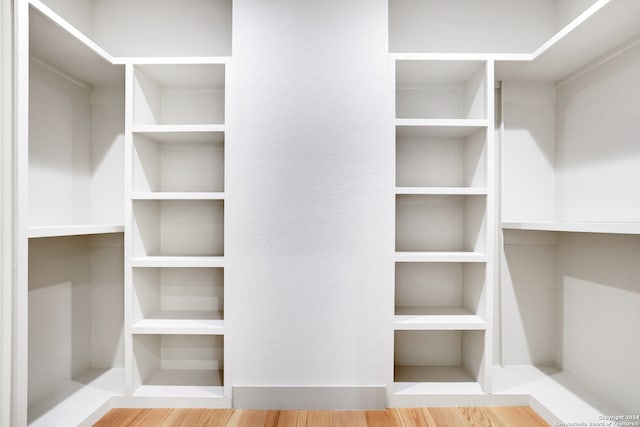 spacious closet featuring hardwood / wood-style flooring