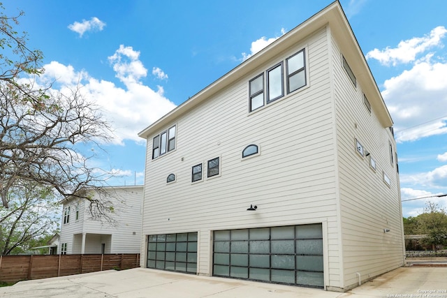 218 Pinckney St, San Antonio, TX 78209 - view of property exterior featuring an attached garage, driveway, and fence