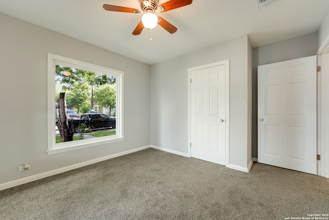 unfurnished bedroom with carpet floors and ceiling fan