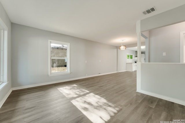 empty room featuring hardwood / wood-style flooring and plenty of natural light