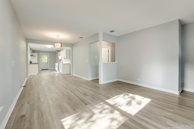 unfurnished living room featuring light wood-type flooring