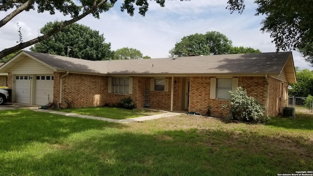 single story home featuring a front yard, brick siding, fence, and an attached garage