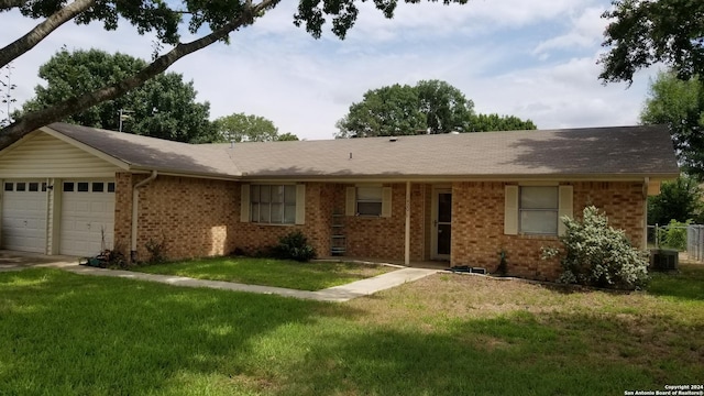 ranch-style house featuring an attached garage, a front yard, and brick siding