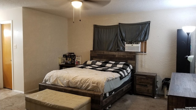 carpeted bedroom with cooling unit, a textured wall, baseboards, and ceiling fan