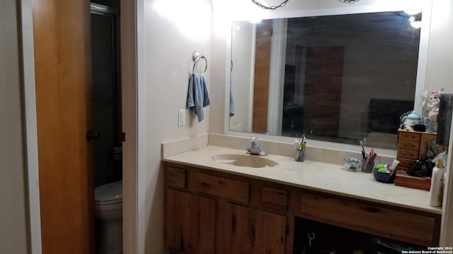 bathroom with toilet and vanity