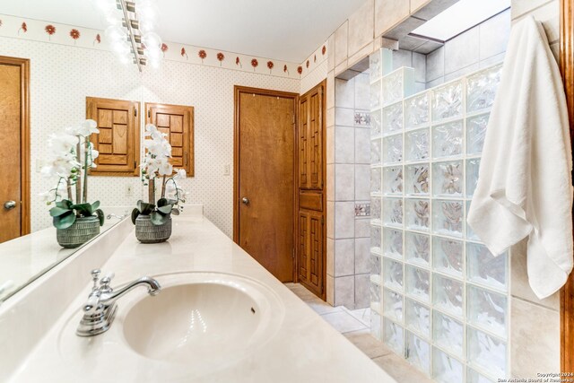 unfurnished bedroom featuring light carpet, ensuite bath, a closet, and ceiling fan