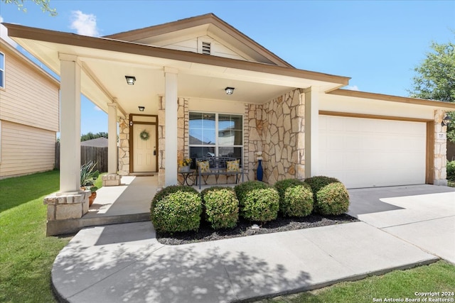 view of front of property with a porch and a garage