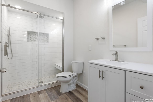 bathroom with walk in shower, wood-type flooring, toilet, and vanity