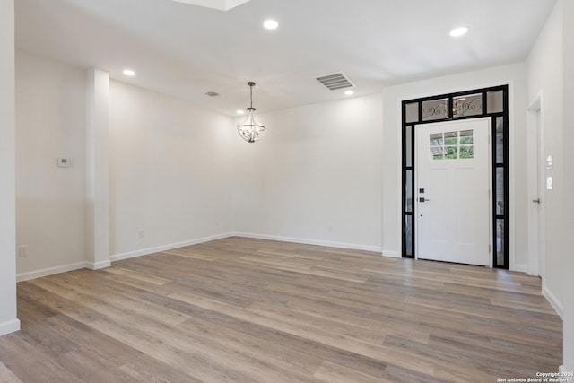 entrance foyer featuring a notable chandelier and light wood-type flooring