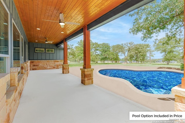 view of swimming pool with ceiling fan and a patio area