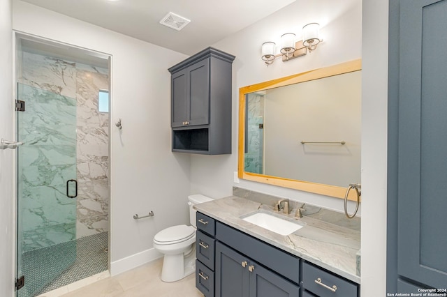 bathroom with toilet, vanity, and a shower with shower door