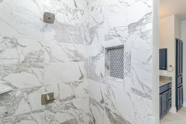 bathroom featuring walk in shower and vanity