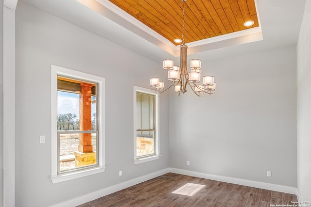 unfurnished room with wood ceiling, a tray ceiling, ornamental molding, and hardwood / wood-style floors