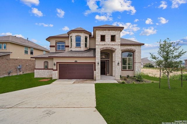 view of front of property with a garage and a front lawn