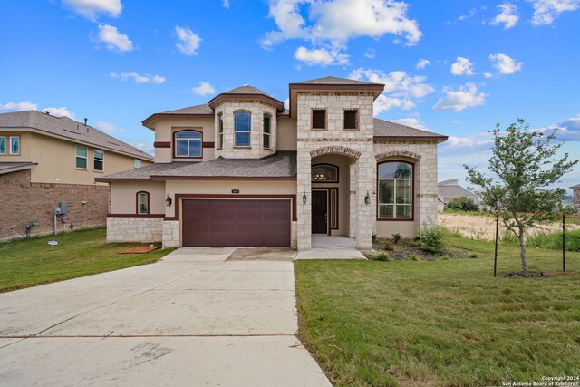 view of front of property with a garage and a front lawn