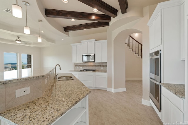 kitchen with white cabinetry, sink, a kitchen island with sink, and stainless steel appliances