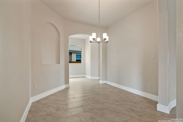 unfurnished dining area with a notable chandelier