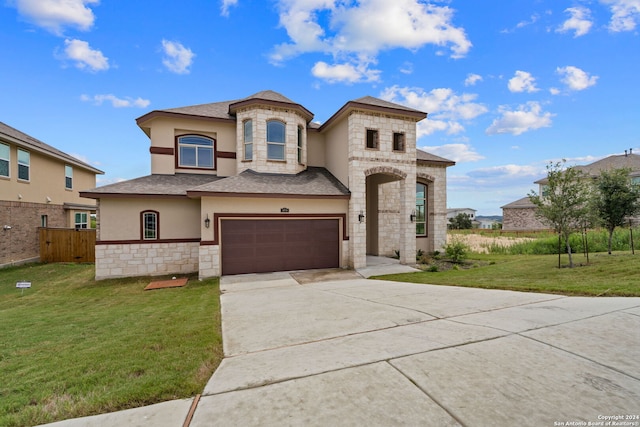 view of front of property with a garage and a front lawn