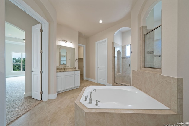 bathroom featuring vanity, shower with separate bathtub, and tile patterned flooring