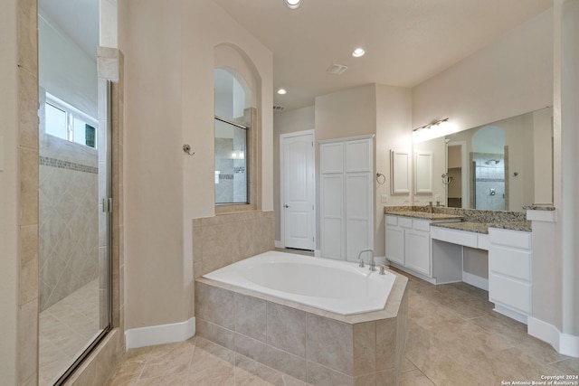 bathroom featuring tile patterned flooring, shower with separate bathtub, and vanity