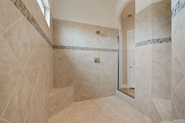 bathroom with a tile shower