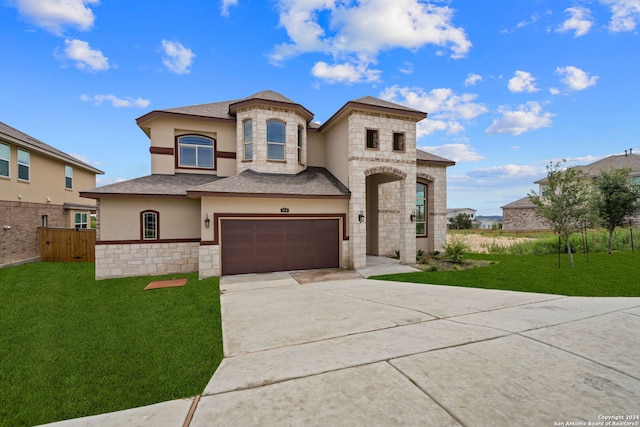 view of front of house with a garage and a front lawn