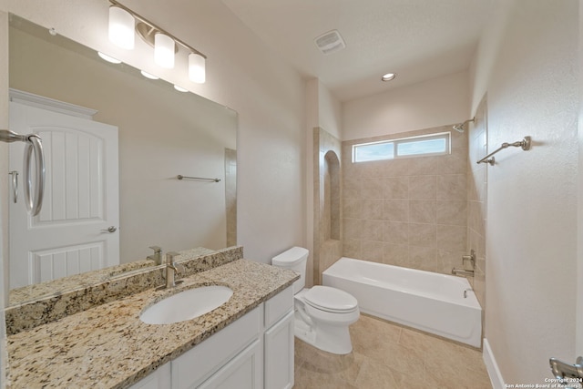 full bathroom featuring tiled shower / bath combo, vanity, tile patterned flooring, and toilet