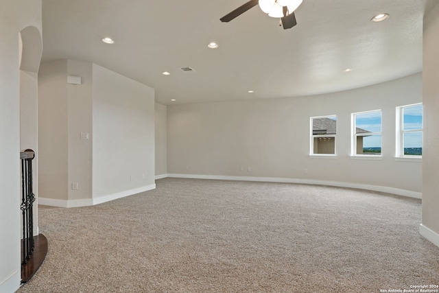 unfurnished room with ceiling fan and carpet floors