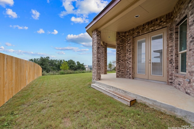 view of yard with a patio and french doors