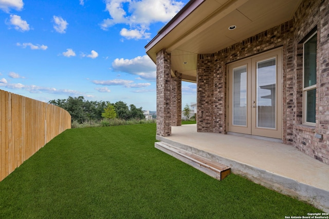 view of yard featuring a patio area and french doors