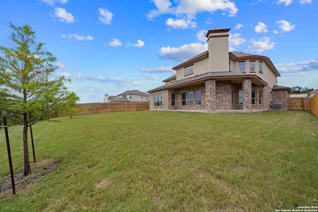 rear view of property with a yard