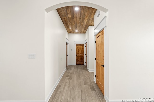 corridor featuring wood ceiling and light wood-type flooring