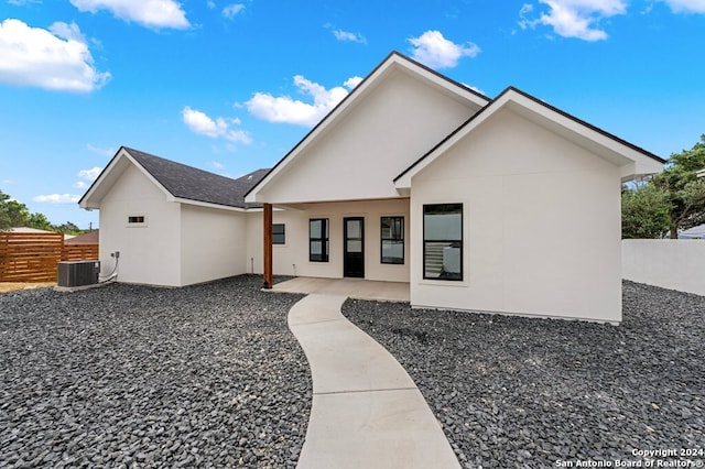 view of front of home with central AC and a patio