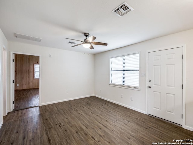 spare room with dark hardwood / wood-style floors and ceiling fan