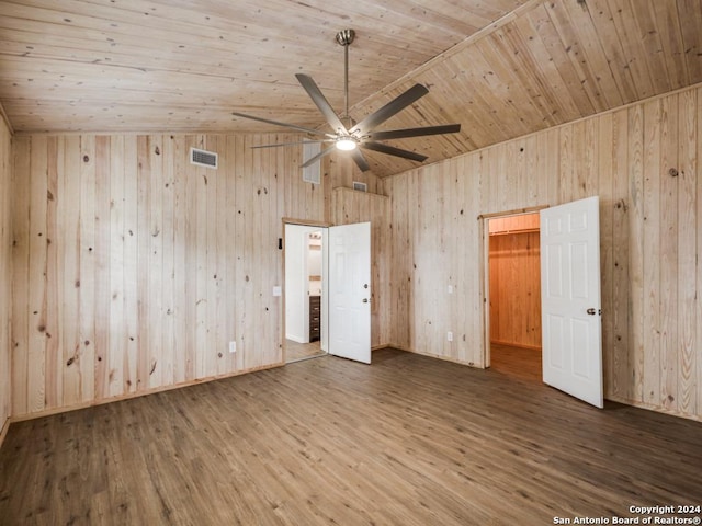 unfurnished bedroom with wood-type flooring, wooden ceiling, and wood walls