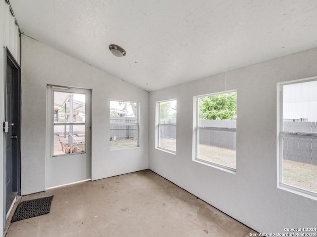 unfurnished sunroom featuring lofted ceiling