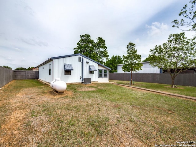 exterior space with cooling unit and a lawn