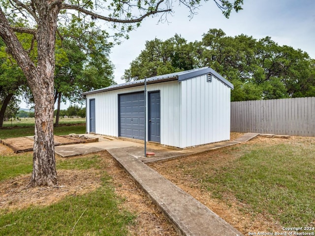 view of outdoor structure with a garage and a yard