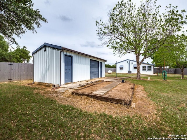 view of outdoor structure featuring a yard and a garage