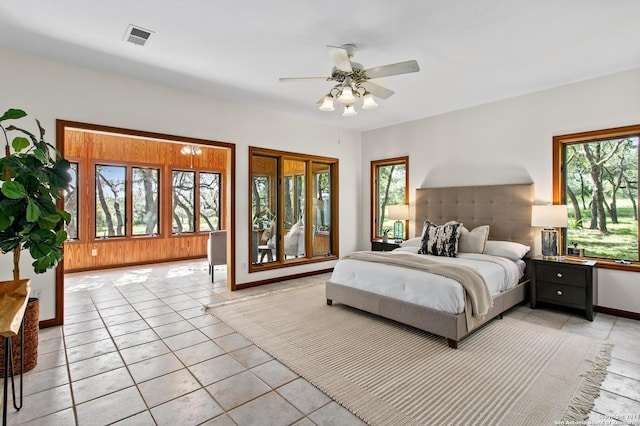 bedroom featuring light tile patterned floors, visible vents, baseboards, and ceiling fan