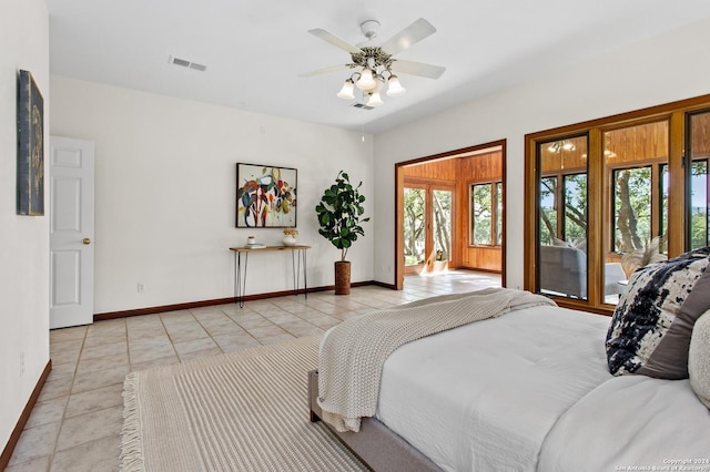 bedroom with access to outside, light tile patterned flooring, baseboards, and visible vents