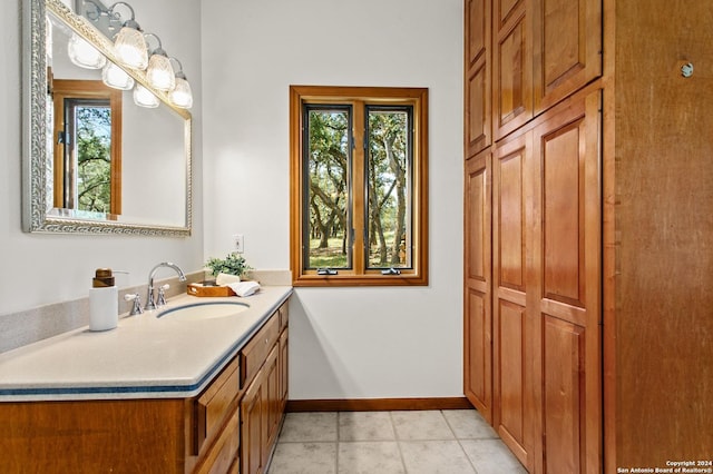bathroom featuring tile patterned floors, a wealth of natural light, vanity, and baseboards