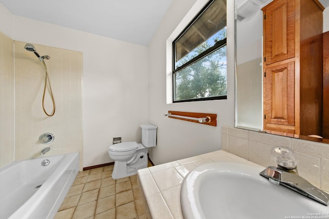 bathroom with baseboards, tile patterned floors, shower / bath combination, toilet, and a sink