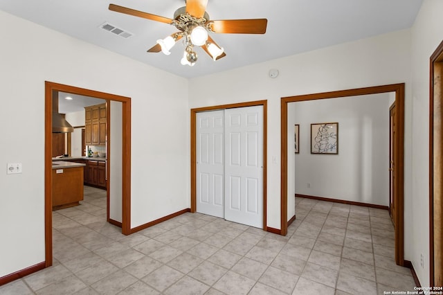unfurnished bedroom featuring a closet, baseboards, and visible vents
