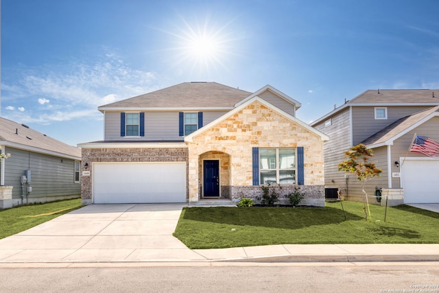 front facade featuring a garage, a front lawn, and central AC unit