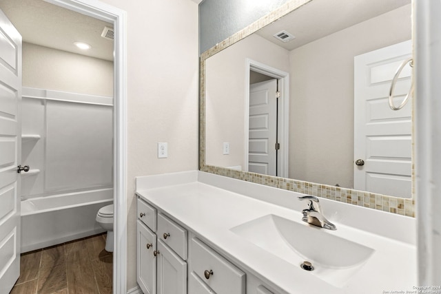 full bathroom with vanity, toilet, bathtub / shower combination, and hardwood / wood-style floors