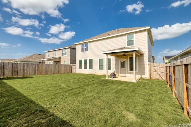 back of property with a patio area and a yard