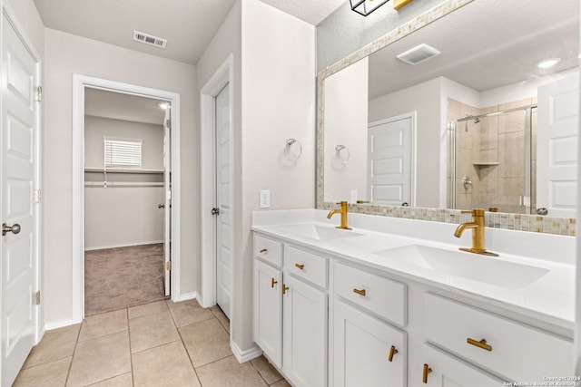 bathroom with vanity, a textured ceiling, a shower with curtain, and tile patterned flooring