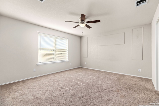 spare room featuring carpet floors and ceiling fan