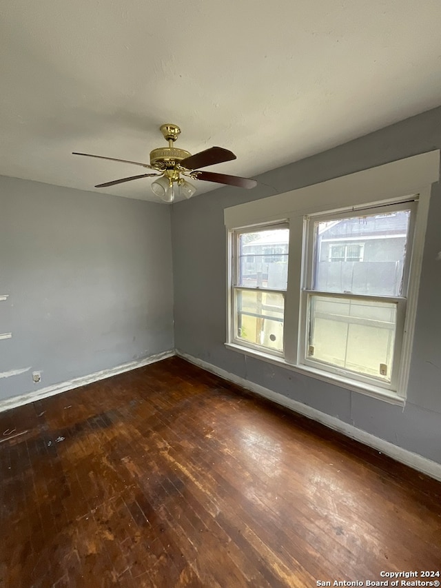 empty room with ceiling fan and wood-type flooring